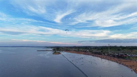 Drone tracking powered paraglider over Balneario Costa Sur beach in Posadas 動画素材 328272131
