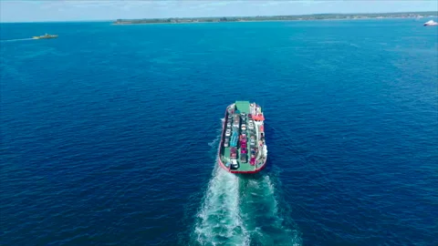 Drone tracking red boat with coast background Vídeos de archivo 340994909