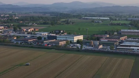 Drone tracking regional passenger train near Fiorenzuola d'Arda in Emilia Stock Footage 334725356