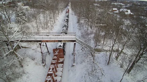 Drone: Tracking Reverse over a Freight Train in the Snow Stock Footage 61855649