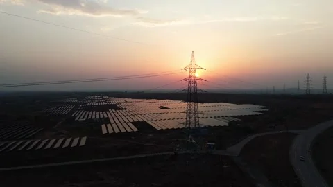Drone Tracking Right to Left Past High Voltage Transmission Tower and Solar Stock Footage 338066425