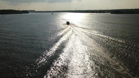 Drone tracking sailboat across bright river water Video stock 333624043