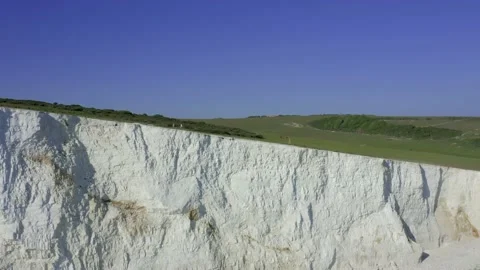A drone tracking shot along the Cliff edge of Seven Sisters White Cliffs Stock Footage 131417451