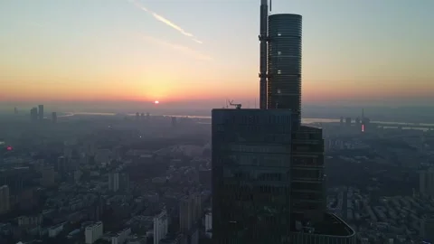 Drone tracking shot around a tall building at sunset 動画素材 255018427