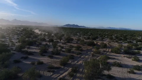 Drone tracking shot of Baja 1000 dune buggy open desert Stock Footage 104883889