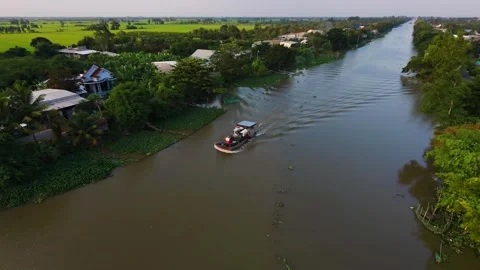 Drone Tracking Shot of Boat Transporting Harvester Machinery on Canal Stock Footage 343606674