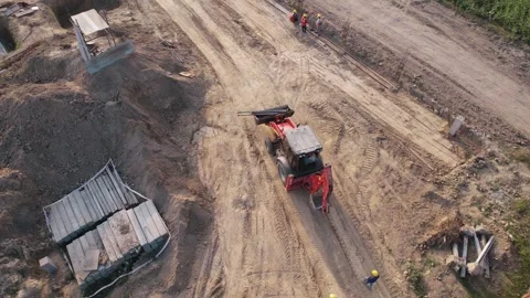 Drone tracking shot of excavator moving at construction site 스톡 동영상 334116746