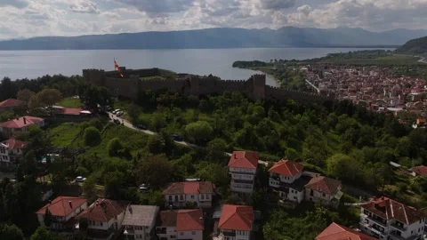 Drone Tracking Shot Flying Past Samuel's Fortress and Flag over Lake Ohrid Stock Footage 337177751