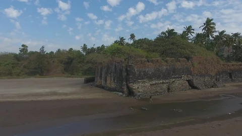 Drone tracking shot of fortification on a beach on West Coast of India Stock Footage 117267367