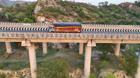 Drone tracking shot of freight lorry crossing concrete viaduct overpass. Stock-Footage 337761642