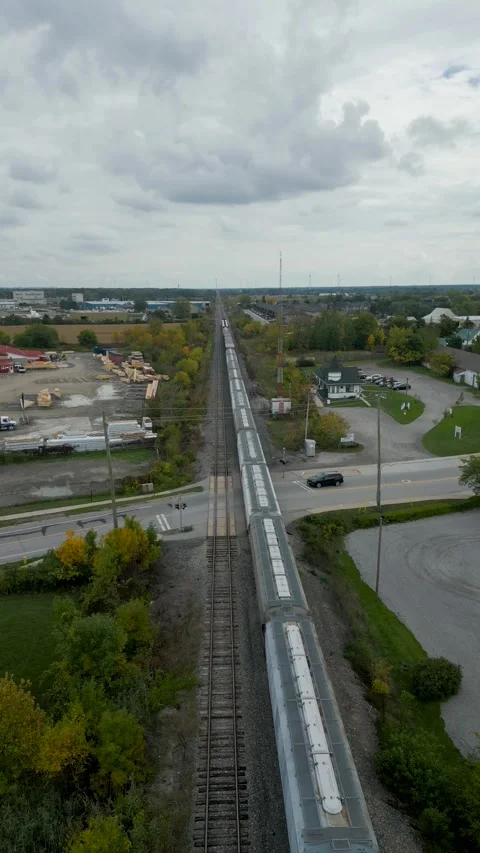 Drone tracking shot of a freight train moving along tracks Video stock 317791051