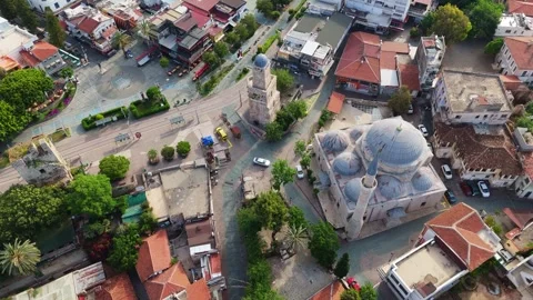 Drone tracking shot looking down at an ancient stone mosque dome inside Kaleici Stock Footage 337667329