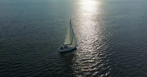 Drone tracking shot of luxury sailing yacht cruising in open blue ocean. Drone Stock Footage 261037657