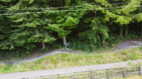 Drone Tracking Shot of Mountain Biker Going Downhill 動画素材 221266305