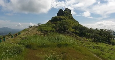 Drone tracking shot of mountain trail with a lake in background. Stock Footage 117404399