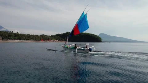 Drone Tracking Shot of Outrigger Sailboat Near Virgin Beach Bali 動画素材 337802284