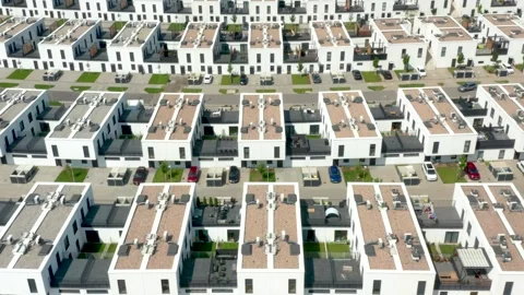 Drone tracking shot over modern white row houses with rooftop terraces in suburb Stock Footage 312593292