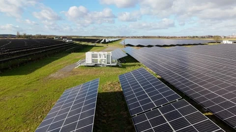 Drone tracking shot over solar photovoltaic array and inverter transformer box 動画素材 339813148