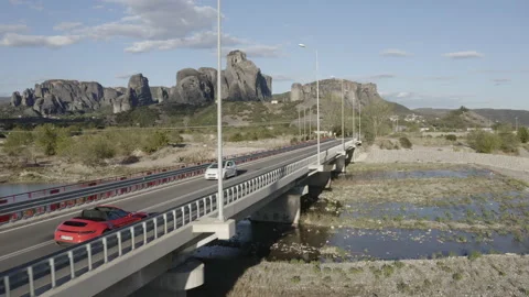 Drone tracking shot of red porsche over bridge in Greece. Video stock 147329013