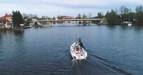 Drone tracking shot of a sailboat with folded sailswimming to port Stock Footage 89416075