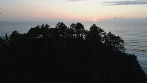 Drone tracking shot of a silhouetted Proposal rock at sunset Stock Footage 249028109