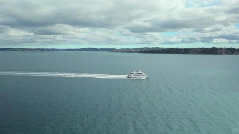 Drone tracking shot of a small ferry with Auckland Transport logo, sailing from Stock Footage 332782945