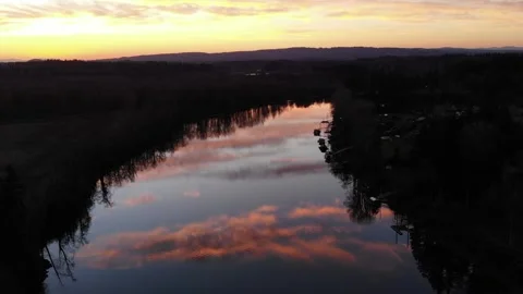 Drone tracking shot of sunset reflected on river Vídeos de archivo 328382791