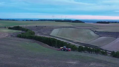 Drone Tracking Shot of Tractor Performing Direct Seeding in Agricultural Fields Stock Footage 326357920