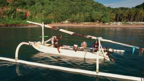 Drone Tracking Shot of Traditional Outrigger Boat Near Virgin Beach Stock Footage 337802208