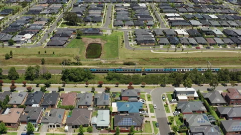 Drone tracking shot of train arriving at an outer suburb in Melbourne, Australia Stock Footage 146211061