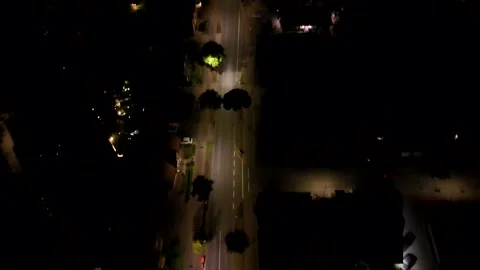 Drone tracking shot of vehicle driving on lighting street at night. Charming Stock Footage 316291015