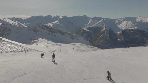 Drone tracking skiers with mountain background Stock Footage 345801671