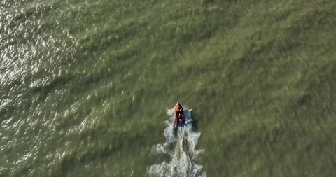 Drone tracking a small speedboat through the sea Stock Footage 345585231