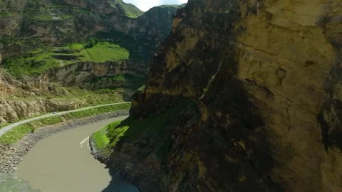 Drone tracking a snaking road along a mountain river at Muchiltalu Ridge, Dagest Stock Footage 303411328