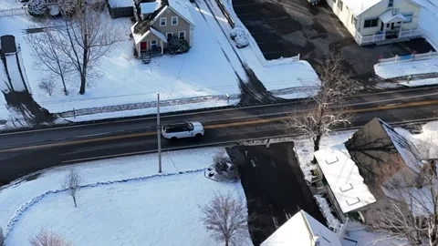 Drone Tracking SUV Stops at Intersection Turns Onto Residential Road Rear Follow Stock Footage 296074898