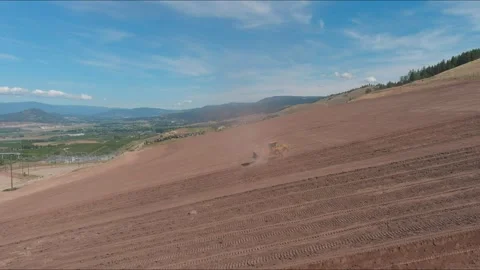 Drone Tracking Tractor Plowing Vineyard Rows in Dusty Field Stock Footage 311514126