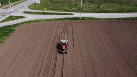 Drone tracking of a tractor in reverse Stock Footage 158388225