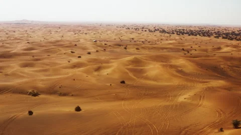 Drone tracking vehicle through Dubai desert into top down view Stockbeeldmateriaal 345097292