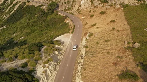 Drone tracking a white car on the coastal road of Mallorca Stock Footage 168200044