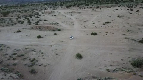 Drone tracking a white SUV forward and backward over a patchwork of road Video stock 200286866