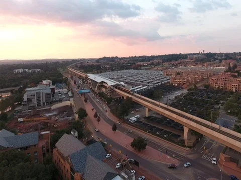 Drone tracks along with high speed Gautrain train at sunset in Centurion Video stock 80721443