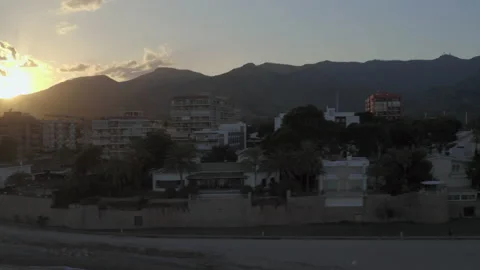 Drone tracks the beach front of a mediterranean holiday resort in the evening Stock-Footage 150340374