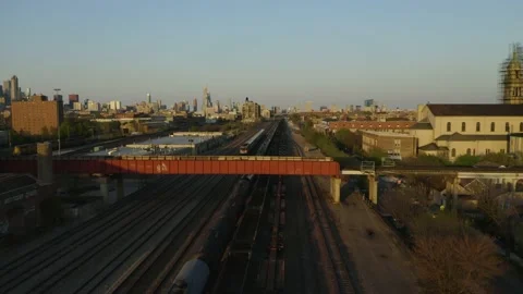 Drone Tracks Metra Train, Pan to Reveal Chicago Skyline from Pilsen Neighborhood Stock Footage 132740189