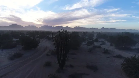Drone tracks right to left across Baja 1000 trophy truck sunset, back lit  Stock Footage 104883961