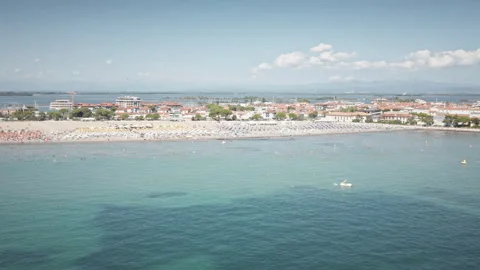 Drone tracks right over Grado island beach and lagoon on a sunny day Video stock 331380744