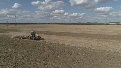 Drone Of Tractor Passing While Ploughing Field 4K Resolution Stock Footage 93149922