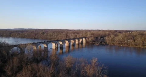 Drone of train overpass crossing the Delaware river 動画素材 127053244
