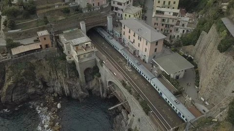 Drone | Train Parked on Coast | Tilt Down Coastal Italian Town  (No Color Grade) Stock Footage 106795785