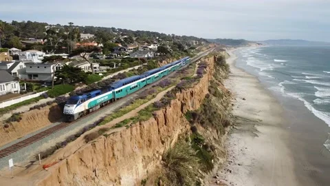 DRONE - TRAIN PASSING - CLIFFS - OCEAN WAVES Stock Footage 138407335