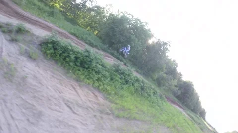 Drone tries to keep up with mx racer jumping 2.7k Stock Footage 52170386